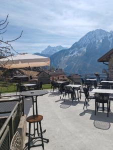a group of tables and chairs with mountains in the background at Casa Elena in Casso