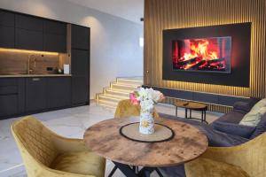 a living room with a table and a fireplace at DINLUX Luxury Apartment in Maribor