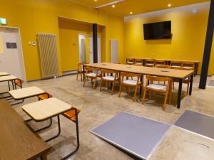 a conference room with a long table and chairs at Cabin kutekun in Naka-shibetsu