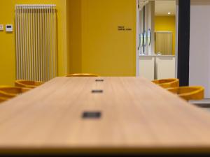 a large wooden table in a room with chairs at Cabin kutekun in Naka-shibetsu
