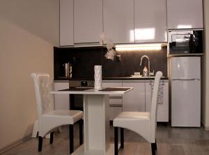 a kitchen with a table and chairs and a refrigerator at Apartment Centrum number 8 in Poprad