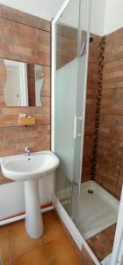 a bathroom with a sink and a shower at Hôtel de Paris - Narbonne in Narbonne