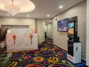 a lobby with a video game machine on a colorful floor at Love Inn Hotel Kuchai Lama in Kuala Lumpur