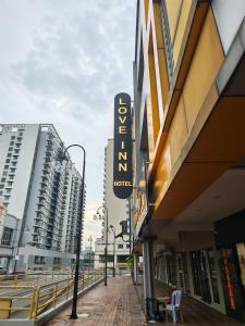 a hotel sign on the side of a building at Love Inn Hotel Kuchai Lama in Kuala Lumpur