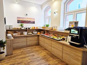 a restaurant with a buffet line with food at Pension bei der Marienkirche in Mühlhausen +29 photos