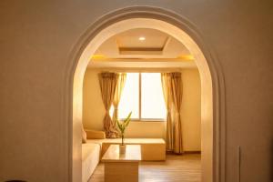 an archway in a room with a couch and a window at Thamel Central Apartment in Kathmandu +7 photos
