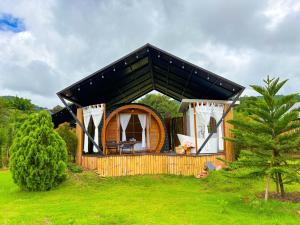 a small wooden cabin with a black roof at นวนิยาย Nava-Niyay in Ban Huai Ti +10 photos