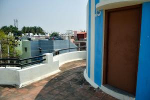 a door to a building with a view of a city at Pandiyan guest house in Madurai