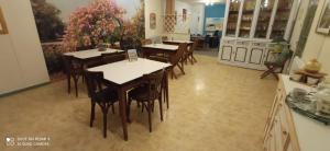 a group of tables and chairs in a room at Hôtel de Paris - Narbonne in Narbonne +15 photos