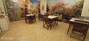 a rendering of a restaurant with tables and chairs at Hôtel de Paris - Narbonne in Narbonne