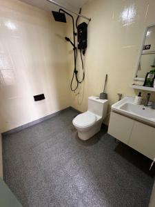 a bathroom with a toilet and a sink at The Regency PortDickson A1-6 in Port Dickson