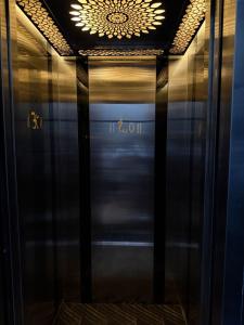 a glass elevator door with a chandelier above it at Dayanand Residency in Chitradurga