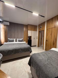 a large bedroom with two beds and a kitchen at Orient Lux in Yakkasaray