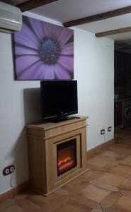 a living room with a fireplace with a tv on top at L'Atalaya D'or in Oropesa del Mar
