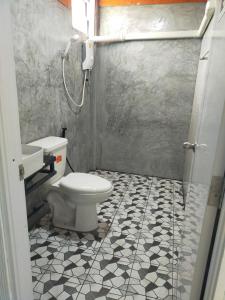 a bathroom with a toilet and a sink at Good View Guest House in Phatthalung +23 photos