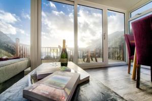 a living room with a bottle of wine on a table at Portamaggie Cottage in Portpatrick