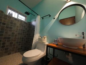 a bathroom with a toilet and a sink and a mirror at Casa ilusion Tuxpan Veracruz in Tampamachoco