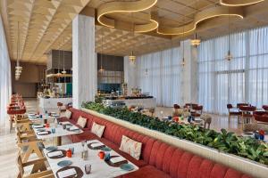 a restaurant with tables and chairs in a room at Fortune Select Siliguri- Member ITC Hotels' Group in Siliguri