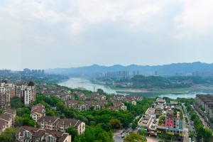 an aerial view of a city with a river and buildings at 两江万励OneJasper空中江景酒店 in Chongqing