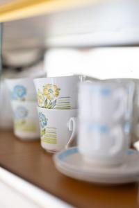 a pile of cups and plates on a table at Natural retreat in Makri