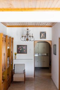 a living room with a chandelier and a hallway at Natural retreat in Makri +20 photos