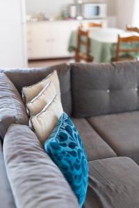 a brown couch with two pillows on it at Natural retreat in Makri