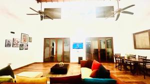 a living room with a couch and a table at Mara Villa Katunayake - 5 Mins to Colombo Airport in Katunayaka