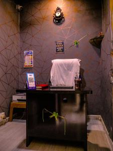 a room with a desk with a laptop on it at Hotel GK Lodging & Boarding in Khāpri