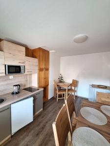 a kitchen and dining room with a table and chairs at Pr' Hribar in Zgornje Gorje