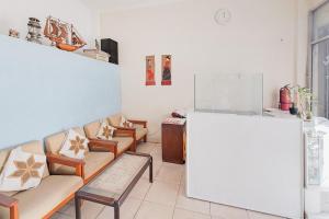 a waiting room with couches and a large whiteboard at RedDoorz at Arca Hostel Lampung in Lampung