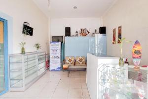 a room filled with lots of different items on display at RedDoorz at Arca Hostel Lampung in Lampung