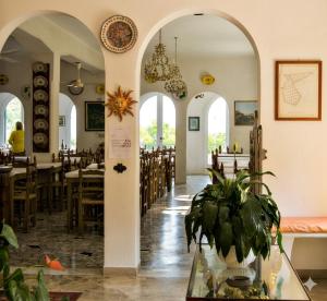 a restaurant with tables and chairs and a potted plant at Hotel Villa Furia in Bellaria-Igea Marina