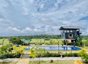 a villa with a swimming pool and a house at The Lark Resort ,induruwa in Induruwa +31 photos