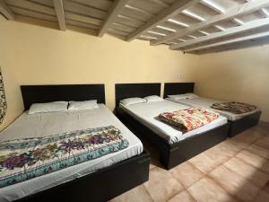 two beds sitting next to each other in a room at giri stay in Aldūr