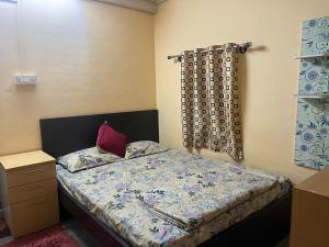 a bedroom with a bed with a pillow and a window at giri stay in Aldūr