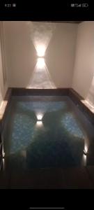a pool of water with two lights in it at Gallendra Villa in Karangploso
