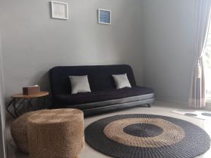 a living room with a couch and a rug at Gallendra Villa in Karangploso
