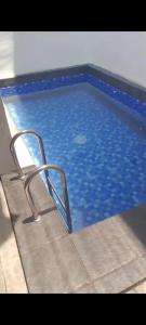 a swimming pool with a chair in the water at Gallendra Villa in Karangploso