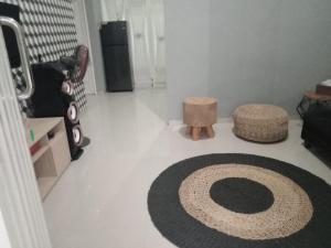 a living room with a large rug on the floor at Gallendra Villa in Karangploso