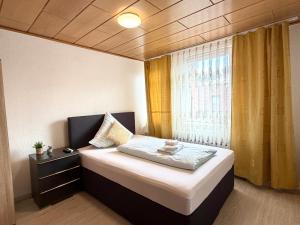 a bedroom with a large bed with a window at Asia Oase in Arendsee