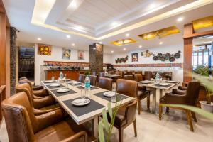 a restaurant with tables and chairs and a bar at Velocity Corporate Hotel TERMINAL 2,3 Delhi Airport With- Free Airport Pickup in New Delhi