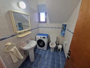 a small bathroom with a sink and a toilet at Marmario Villa 10 in Anarita +15 photos