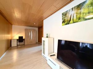 a living room with a large flat screen tv at Asia Oase in Arendsee