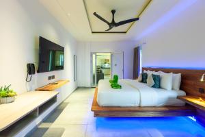 a bedroom with a bed and a tv on the ceiling at Cote d'Or Retreat in Anse Volbert Village +32 photos