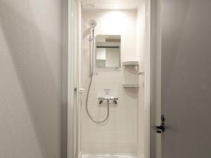 a bathroom with a shower and a sink at Cabin kutekun in Naka-shibetsu +62 photos