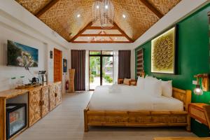 a bedroom with a large white bed and green walls at Casa Verde Cliff Resort & Spa in Camotes Islands