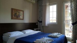a bedroom with a bed with two towels on it at So Dalyan in Ortaca