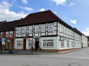a large building with white windows on a street at Asia Oase in Arendsee