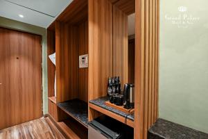 a room with a kitchen with wooden walls and a counter at Grand Palace Hotel & Spa in Yercaud