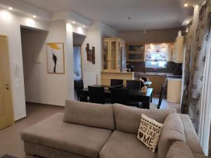 a living room with a couch and a dining room at Stefania's Luxury House in Platamonas